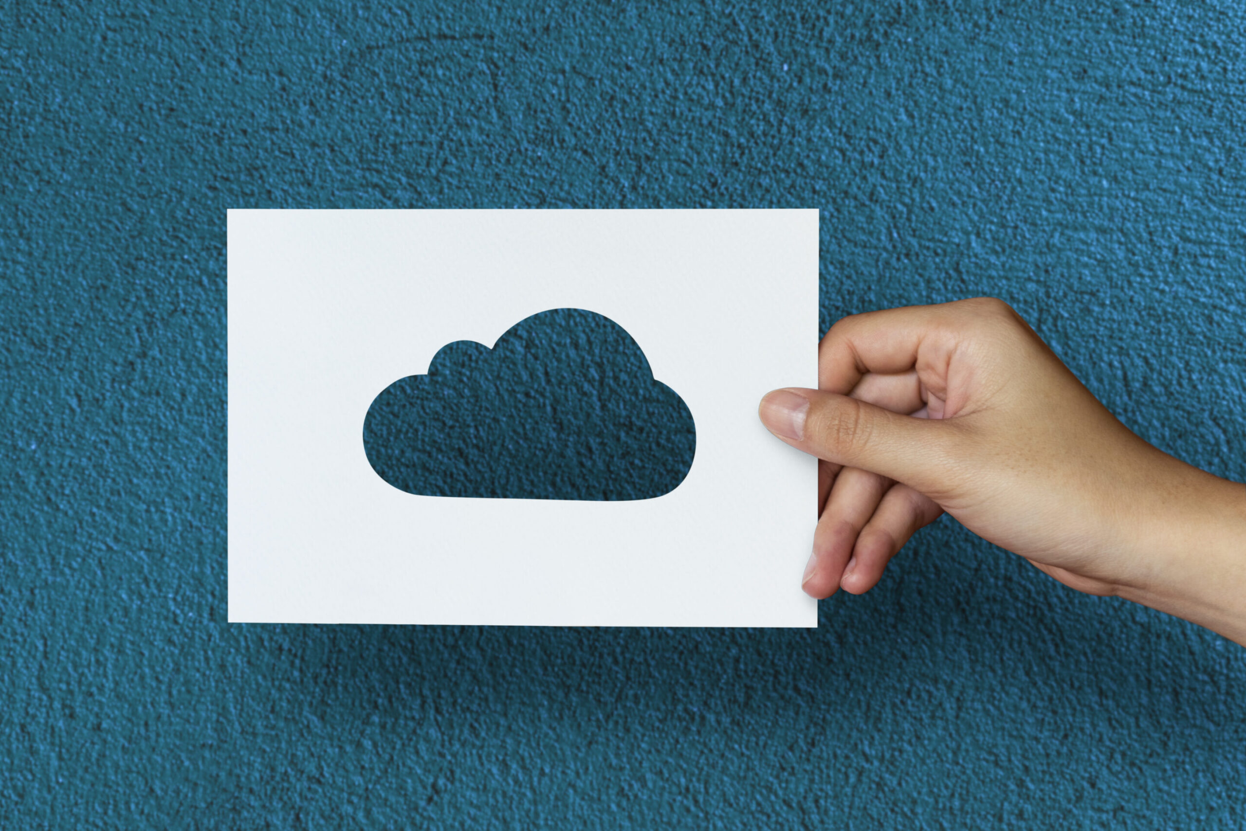 Hand Hold Cloud Paper Carving with Blue Background cloud technology and migration