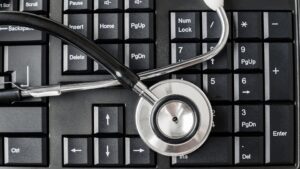 cybersecurity audits - stethoscope on pc keyboard