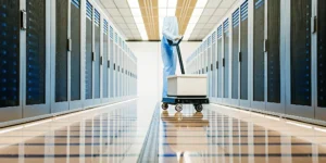 Emergency server data recovery specialist working on a failed server in a clean room.